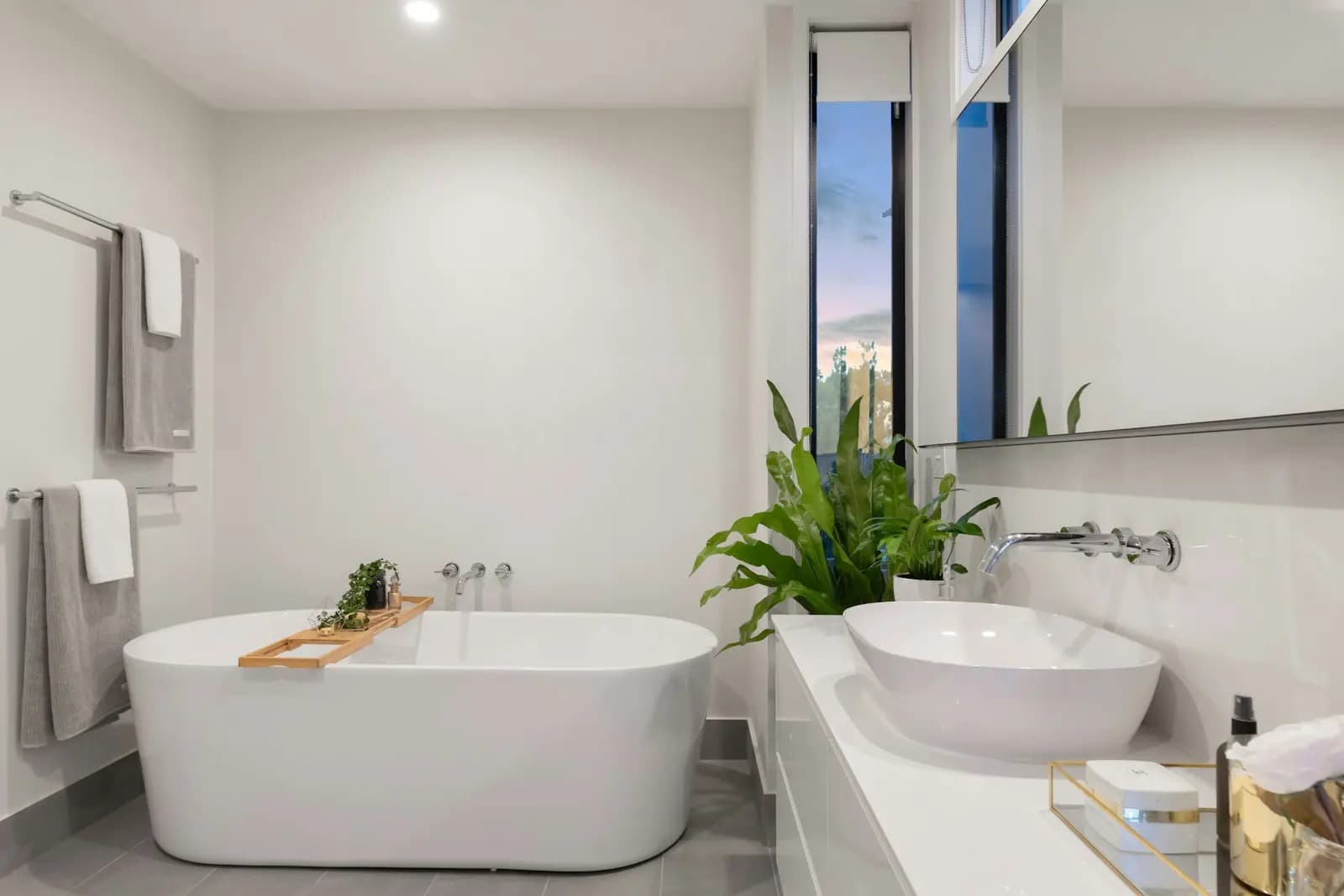 Salle de bain rénovée : baignoire îlot, vasque et robinetterie murale